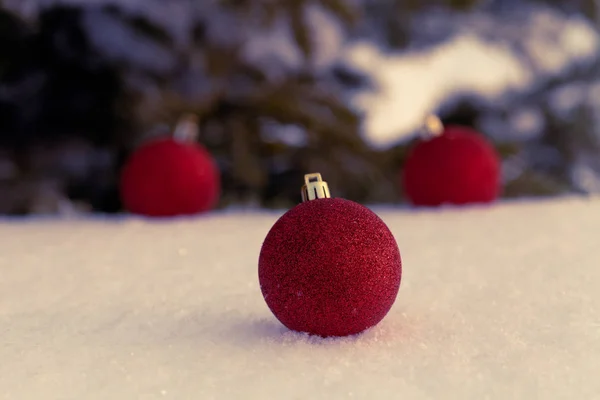 Cristmas tree branches and bright balls on a clean pure snow for — Stock Photo, Image