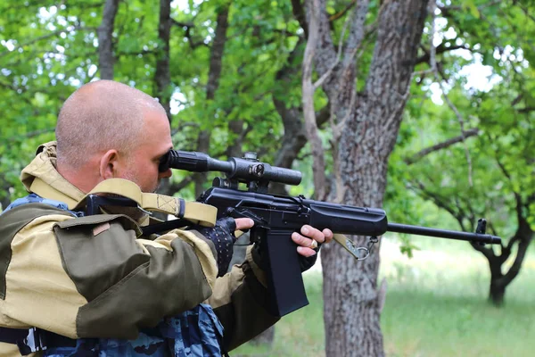 İnsan avcısı ormandaki bir silahtan hedefliyor. Namlu hedefe nişan.