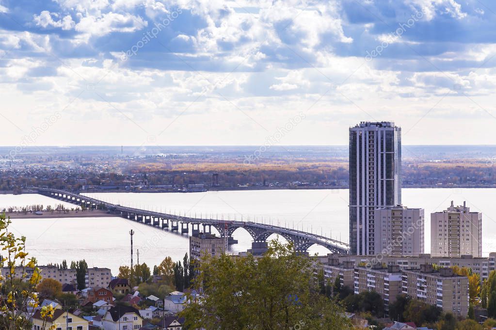 Travel to Russia. Landmark of the Volga region, the bridge over the Volga River between the city of Saratov and Engels near the skyscraper and the city beach. View from Sokolovaya Mountain.