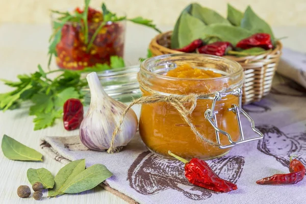 Food. Homemade harvest preservation. Dietary vegetable puree of zucchini, pumpkin, carrot, pepper with spices, garlic and jam in glass jars