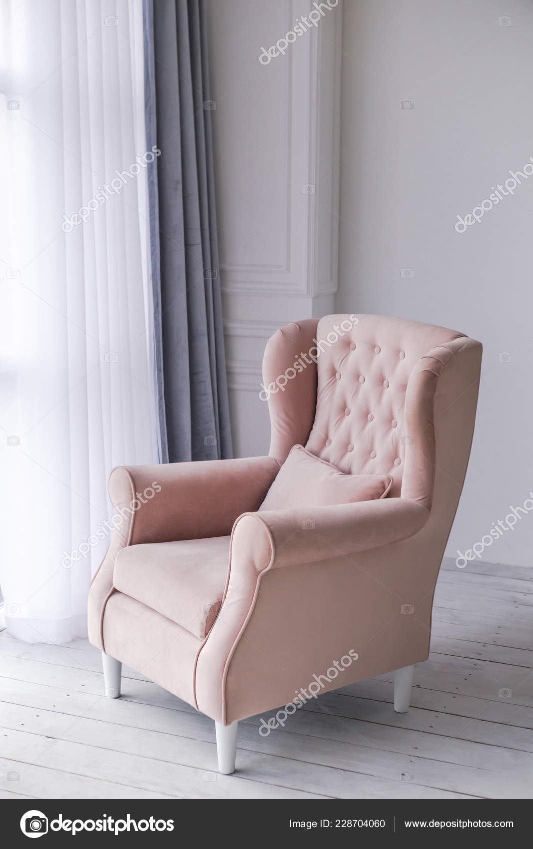 pink armchair in living room near window home interior photo of living  room in light colors home interior design 228704060