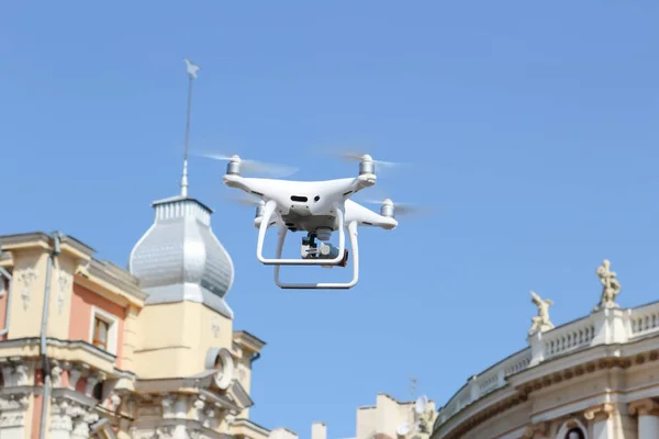 Drone flying in city center. Quadrocopter with camera flying in the city. Drone quadcopter with digital camera.