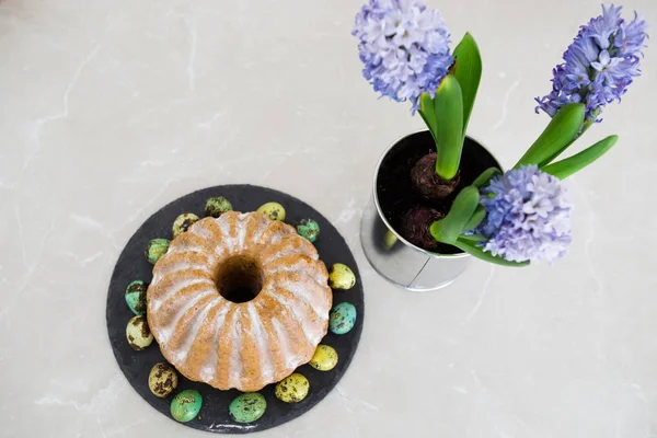 复活节蛋糕在黑色盘子与鹌鹑蛋 开花的风信子在锅里 春天假期的概念 — 图库照片