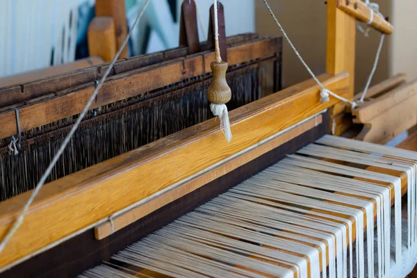 Manual wood loom, old style machine, close up view. Concept of hand made fabric.