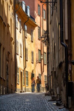 Stockholm dar sokakta yürüyen turistler.