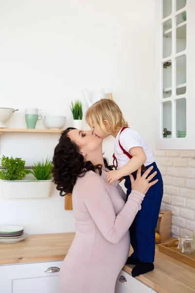 Little blond son kissing mother. — Stock Photo, Image