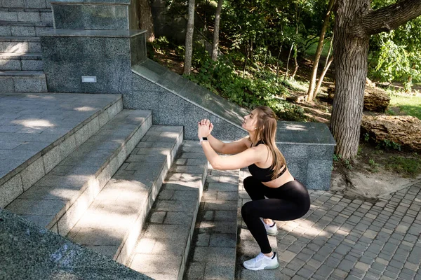 Sporty woman jumping while exercising.