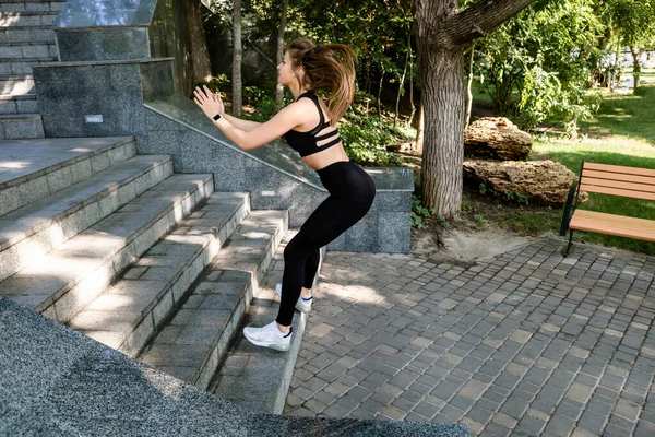 Sporty woman jumping while exercising.