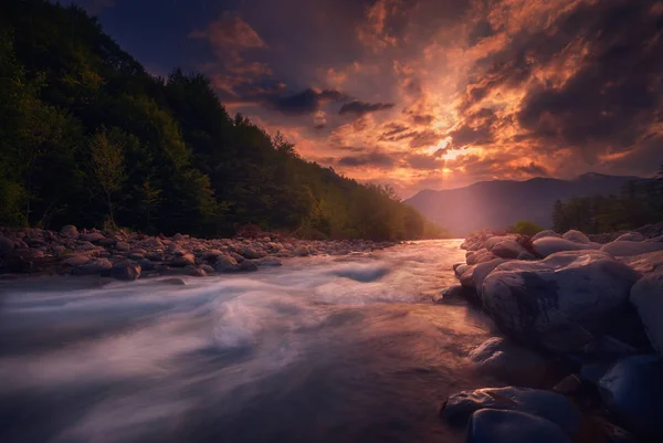 Magischer Sonnenuntergang über dem schnell fließenden Gebirgsfluss — Stockfoto