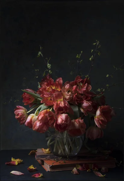 red flowers in vase on dark background