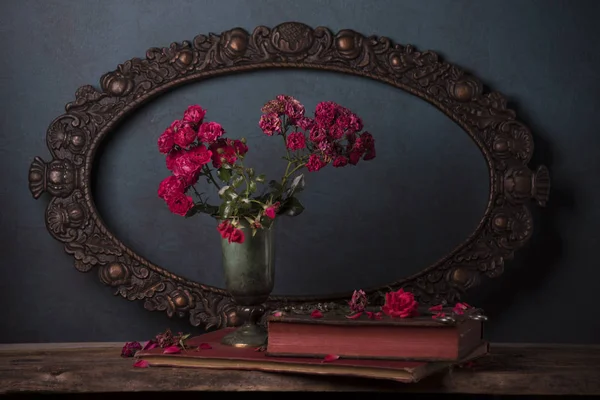 red roses with vintage frame on background