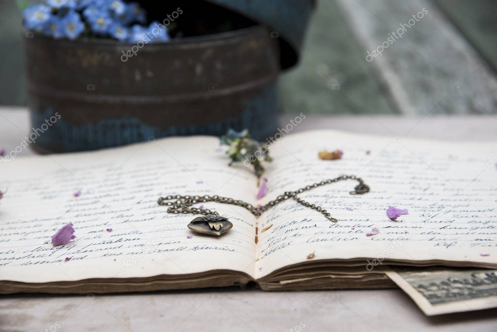 composition of vintage photo, box with blue flowers and amulet
