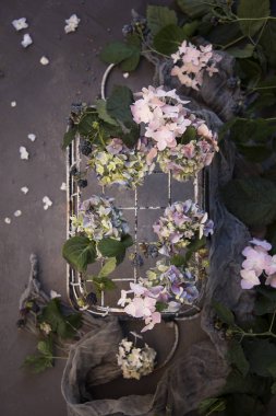taze çiçekler ve eşarp ile rustik metal sepet üstten görünüm