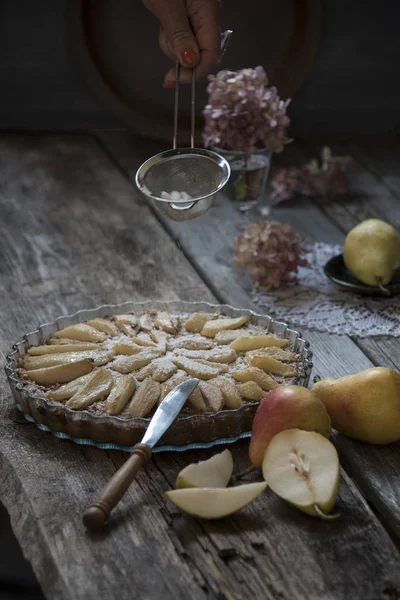 Delicious rustic pie with pears on shabby wooden table