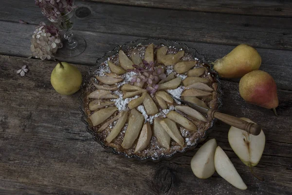 Delicious rustic pie with pears on shabby wooden table