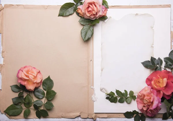 Vintage notepad with copy space and pastel roses