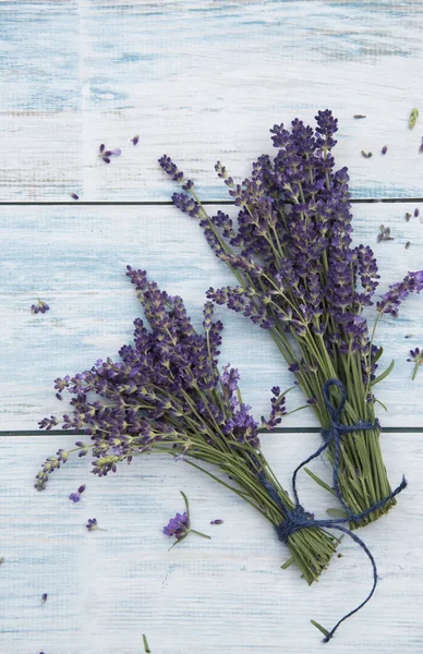 bunches of lavender flowers on white wooden table 