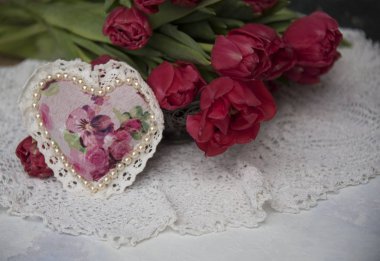 kırmızı lale ve gri arka plan üzerinde kalp yakın çekim 