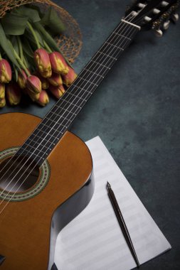 akustik gitar ve Lale çiçek gri arka plan üzerinde kompozisyon