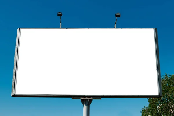 Billboard, billboard, canvas billboard, layout against the blue sky. The concept of outdoor advertising, marketing, sales. mockup