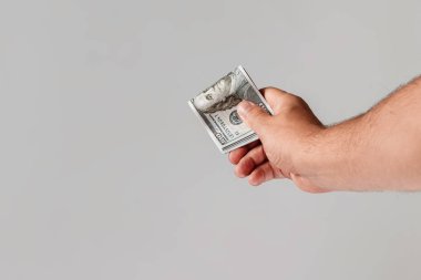 Bize dolar hafif bir arka plan üzerinde bir erkek elinde. Kavram rüşvet, ek iş, maaş, ikramiye, bonus, önbellek geri.