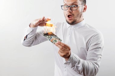 Bir adam bizi dolar yanan elinde, yanan para tutar. Enflasyon, Döviz ve yetki devri satın bir düşüş kavramı.