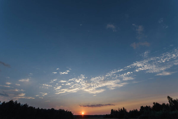 Beautiful foggy landscape, sunset. The fog glowing in the sunlight, above the meadow grass.