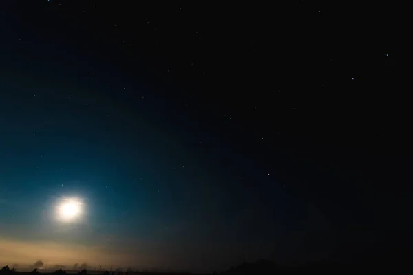 Night moon sky, full moon, Moon over the lake. Night landscape. Reflection of the rays from the moon in the water.