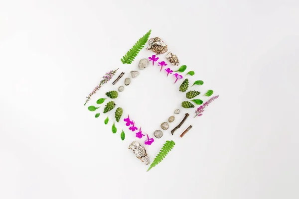 Rhombus frame, Creative layout, natural layout of leaves, stones and wood on a white background. Empty for an advertising card or invitation. The concept of nature. Summer poster. Flat lay. Nature background
