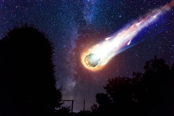 A comet, an asteroid, a meteorite falls to the ground against a starry sky. Attack of the meteorite. Meteor Rain. Kameta tail. End of the world. Astranomy.