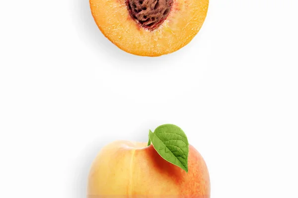 Creative background, peach and slices of peach on a white background. Flat lay, copy space, layout. The concept of nutrition, fresh fruit, natural products, juice.