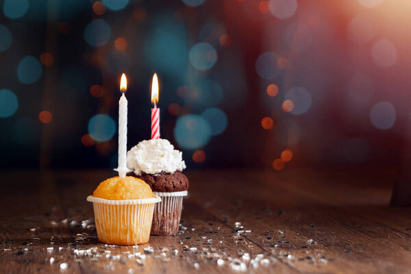 Creative background, cupcake with candles, beautiful bokeh. Happy Birthday. Present. Concept for Holiday Card, Flyer, Background. Copy space