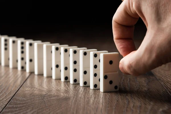 Creative Background Male Hand Pushing White Dominoes Brown Wooden Background — Stock Photo, Image