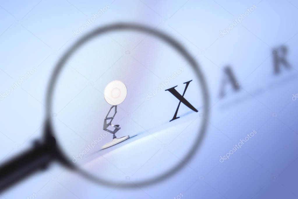 Brest, Belarus, March 15, 2019. Pixar home page, view through a magnifying glass. Pixar company logo is visible. Soft focus.