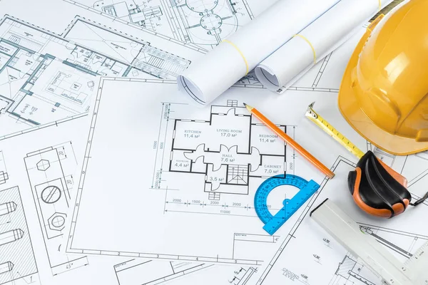 Orange helmet, pencil, architectural construction drawings, tape measure. The concept of architecture, construction, engineering, design. Copy space. — Stock Photo, Image