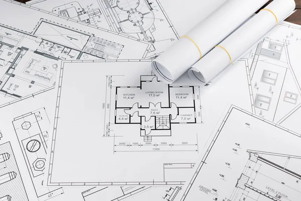 Architectural construction drawings twisted into a roll, construction projects on paper. The concept of architecture, construction, engineering. Copy space.