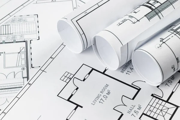 Architectural construction drawings twisted into a roll, construction projects on paper. The concept of architecture, construction, engineering. Copy space. — Stock Photo, Image