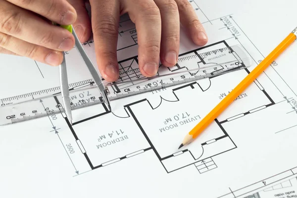 Male hands, Orange helmet, pencil, architectural construction drawings, tape measure. The architect designs the building. The concept of architecture, construction, engineering, design. Copy space. — Stock Photo, Image