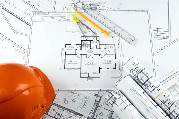 Orange helmet, pencil, architectural construction drawings, tape measure. The concept of architecture, construction, engineering, design. Copy space. — Stock Photo, Image