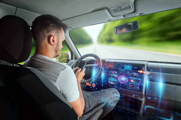 A man in an autonomous car. Self-driving. Concept autopilot, automotive engineering, artificial intelligence
