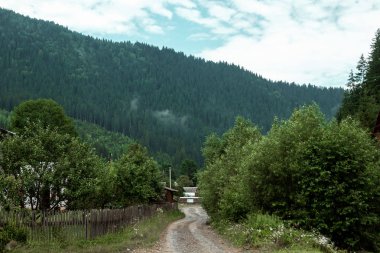 Dağ, güzel yaz manzarası, dağlarda yol, gökyüzü, yaz. Ukrayna, Karpat Dağları. Seyahat, turizm, tatil, tatil kavramı