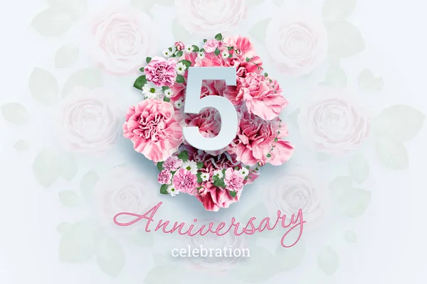 Creative background lettering 5 numbers and anniversary celebration text on pink flowers background. Anniversary concept, birthday, celebration event, template, flyer