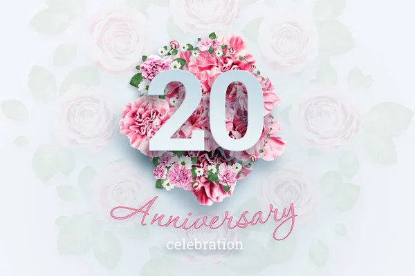 Creative background lettering 20 numbers and anniversary celebration text on pink flowers background. Anniversary concept, birthday, celebration event, template, flyer