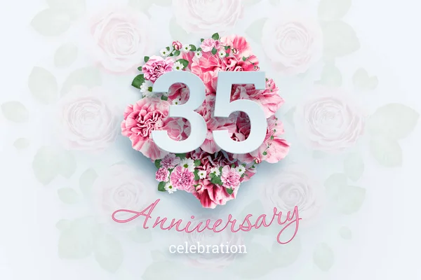 Creative background lettering 35 numbers and anniversary celebration text on pink flowers background. Anniversary concept, birthday, celebration event, template, flyer