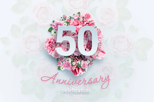 Creative background lettering 50 numbers and anniversary celebration text on pink flowers background. Anniversary concept, birthday, celebration event, template, flyer