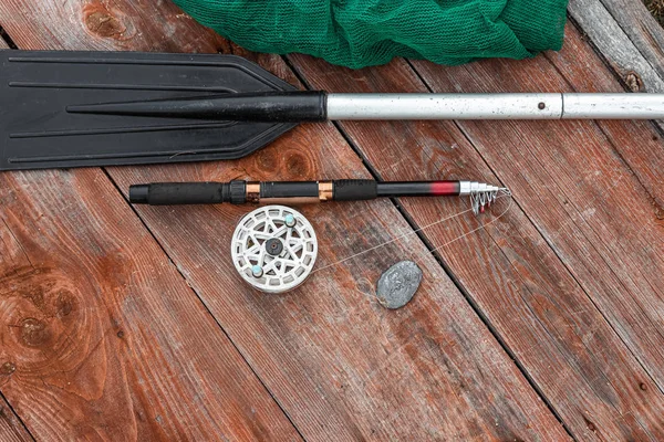 Paddle καλάμι αλιείας και δίχτυα αλιείας σε ένα ξύλινο φόντο πάνω όψη. Ψάρεμα χόμπι διακοπές έννοια. Αντιγραφή χώρου. — Φωτογραφία Αρχείου