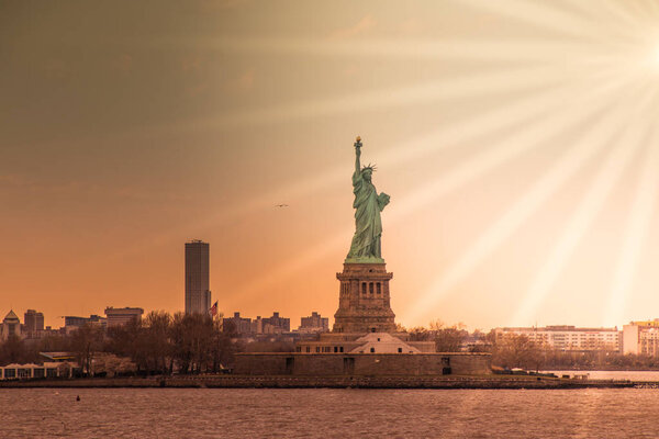 Taking photographs of the Statue of Liberty at sunset