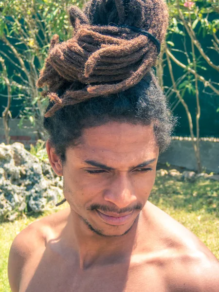 Black man with afro hair and dreadlocks gathered over his head. — Stock Image Black man with afro hair and dreadlocks gathered over his head. Royalty Free Stock Images