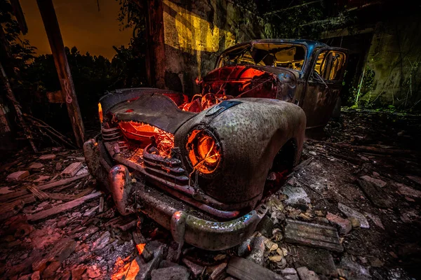 Long exposure with flashlights. Abandoned old car illuminated with flashlights.