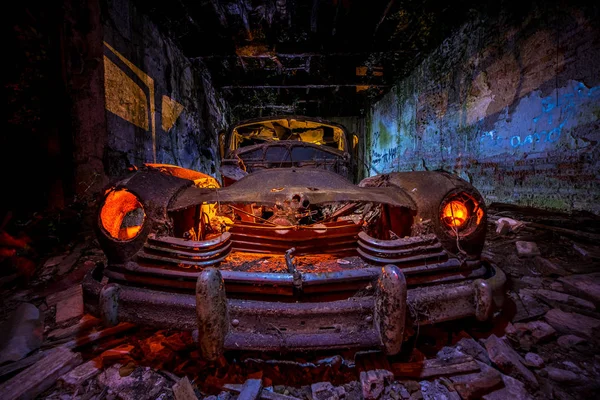 Long exposure with flashlights. Abandoned old car illuminated with flashlights.
